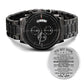 Black wristwatch with a motivational message card on a white background