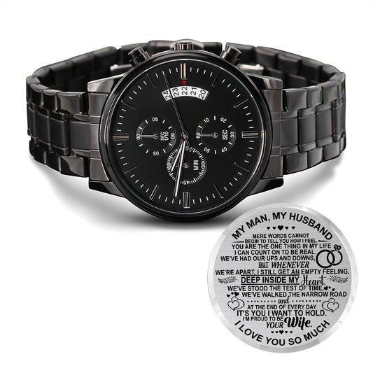 A black stainless steel chronograph watch with a copper dial, featuring a three-dial face, calendar function, and a luxury pointer. The watch has a black band and is presented with an engraved message to a husband.
